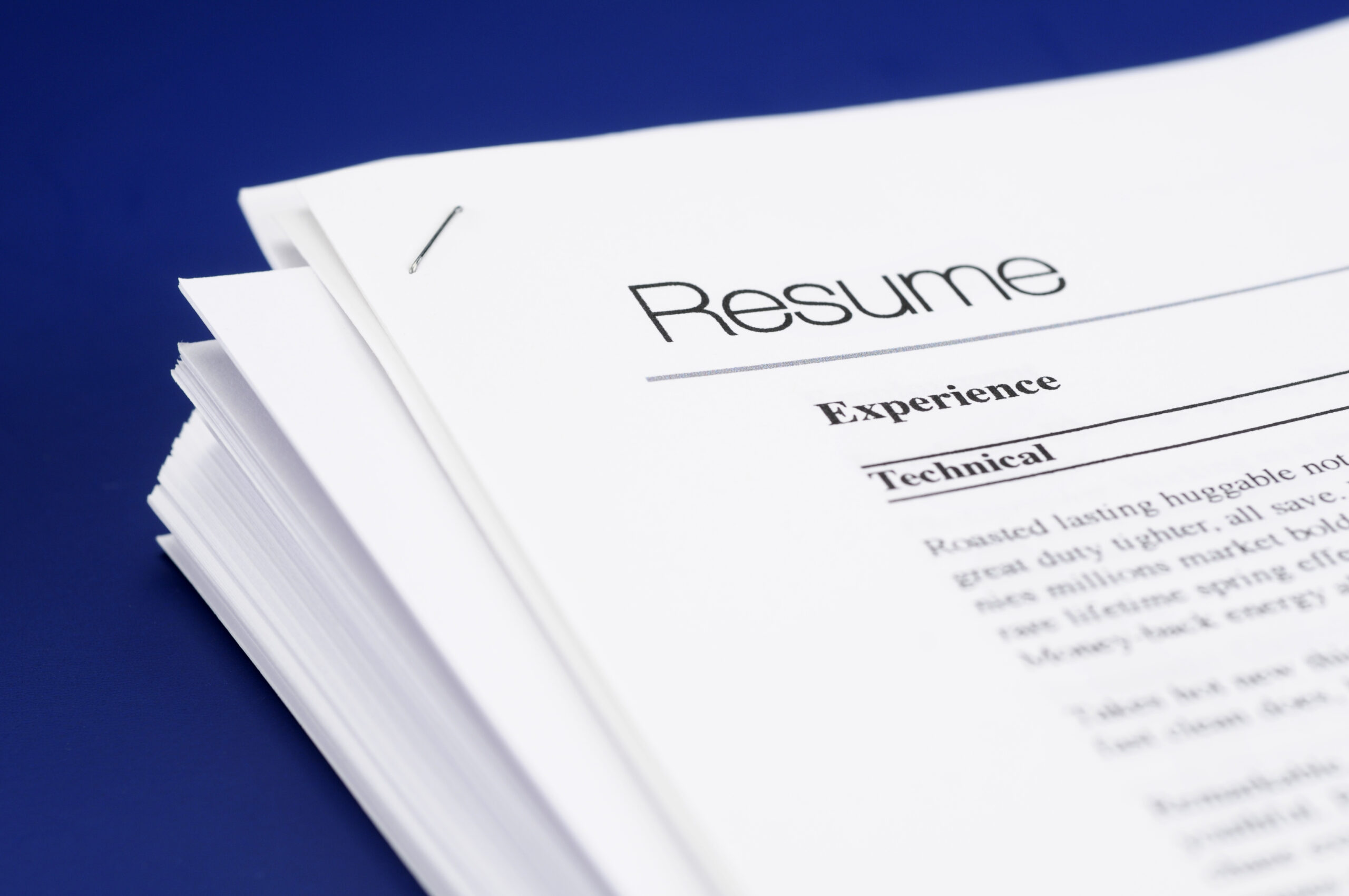 Stock photo of mock resume on blue